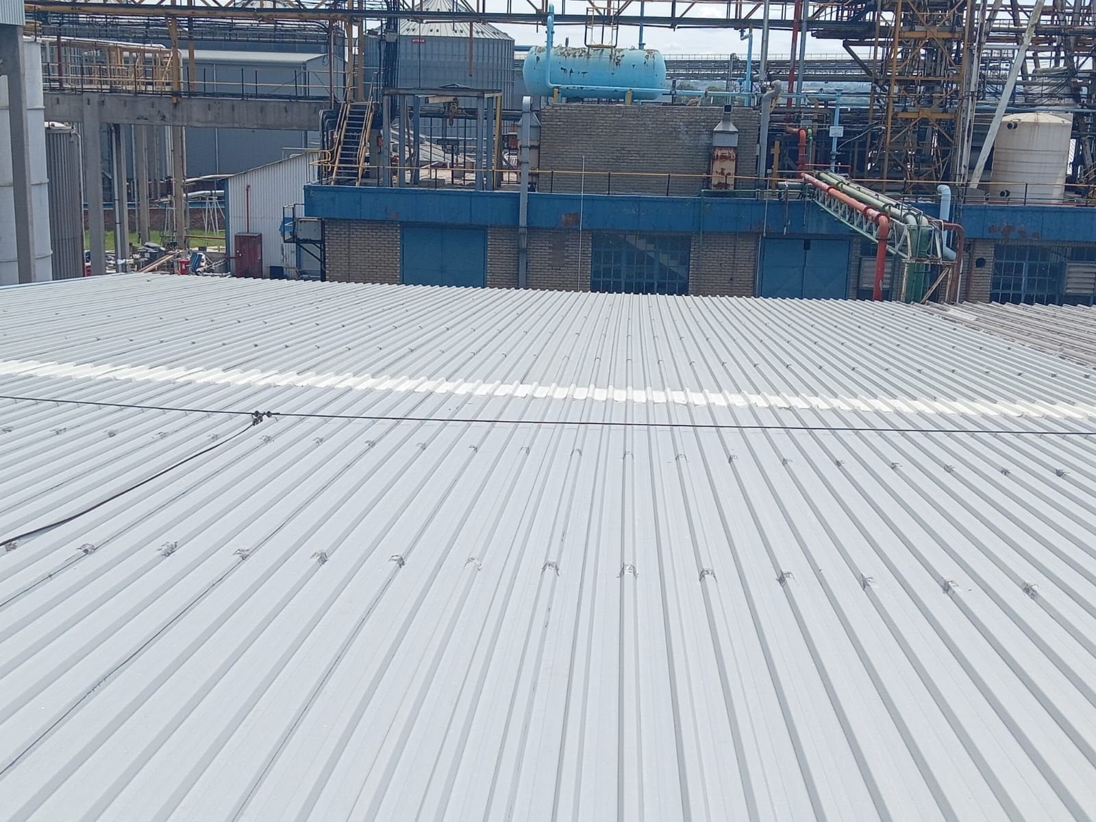 Wide aerial view of industrial roof installation