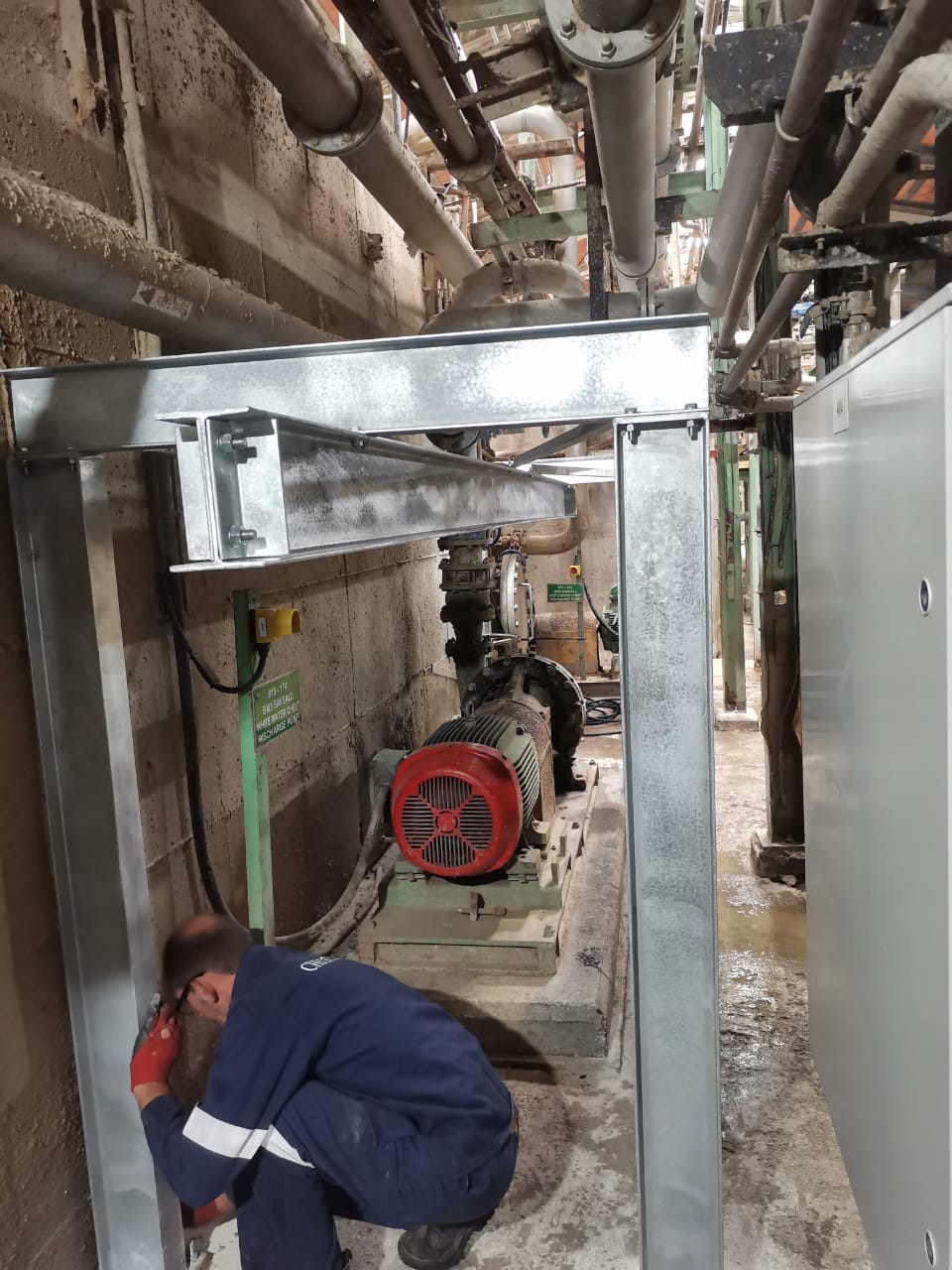 Technician installing steel safety guard
