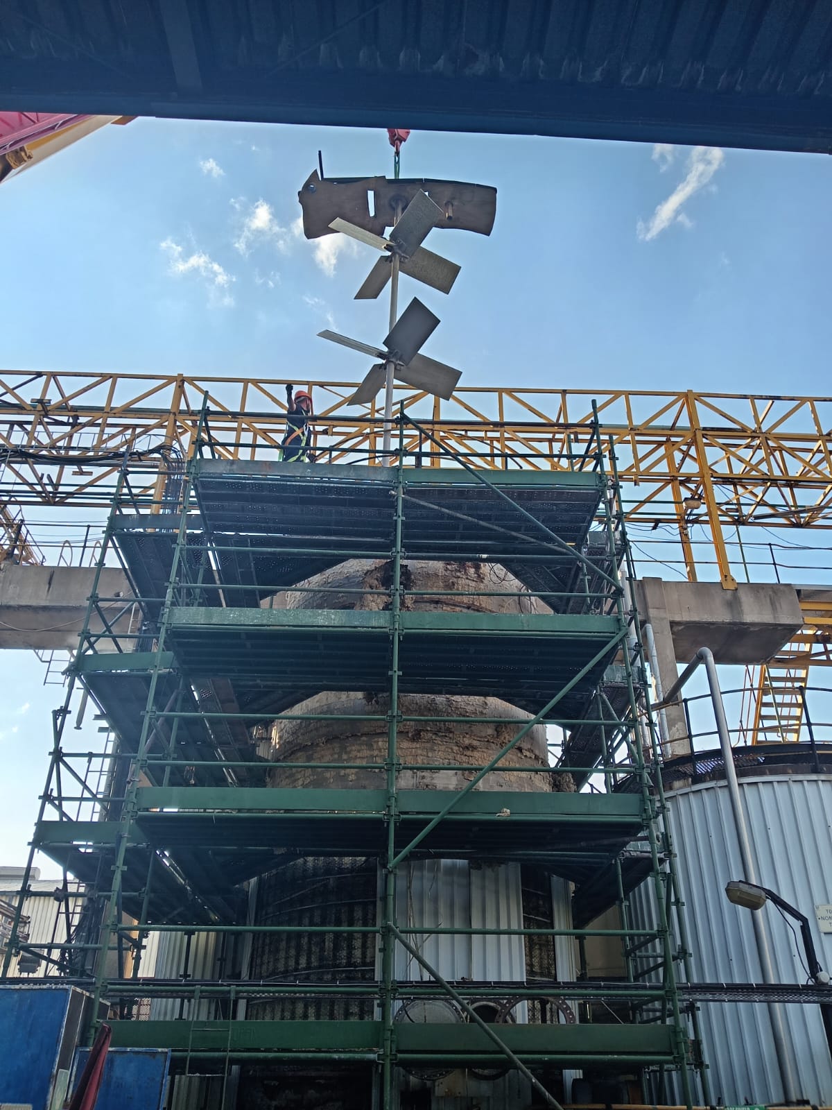 Fan blades being lifted on scaffolding