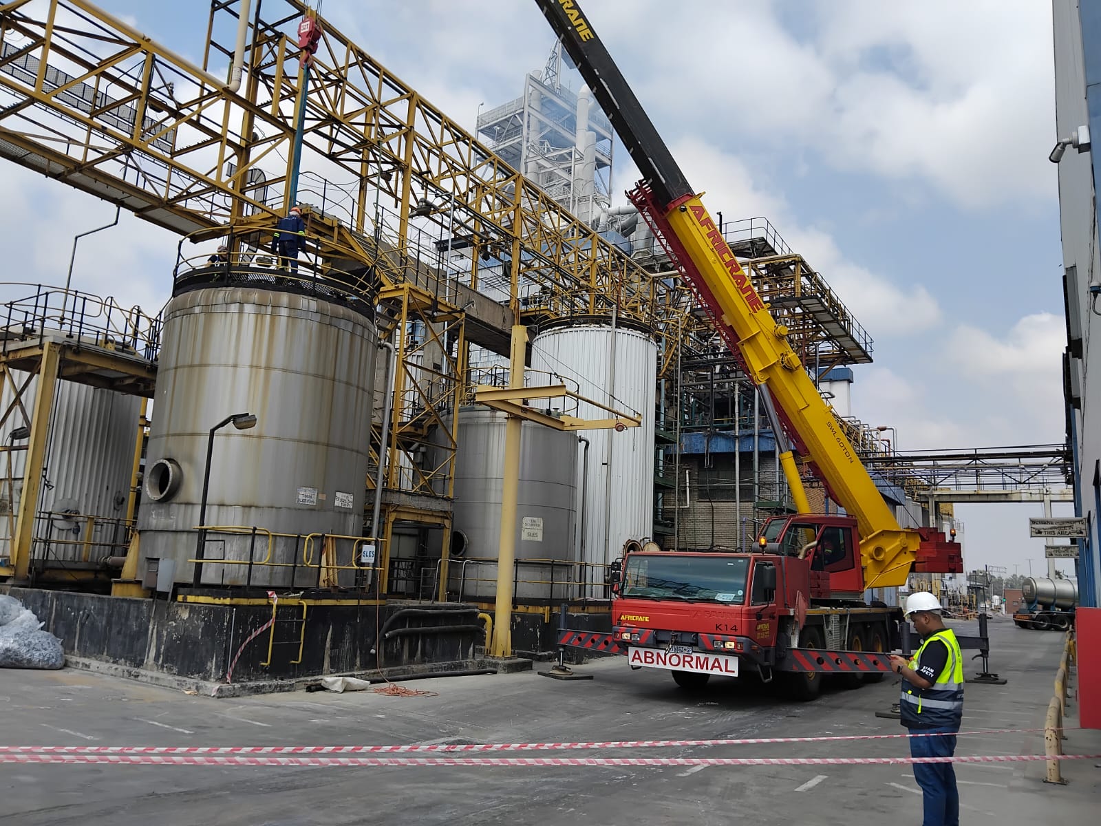 Mobile crane on site at industrial plant complex