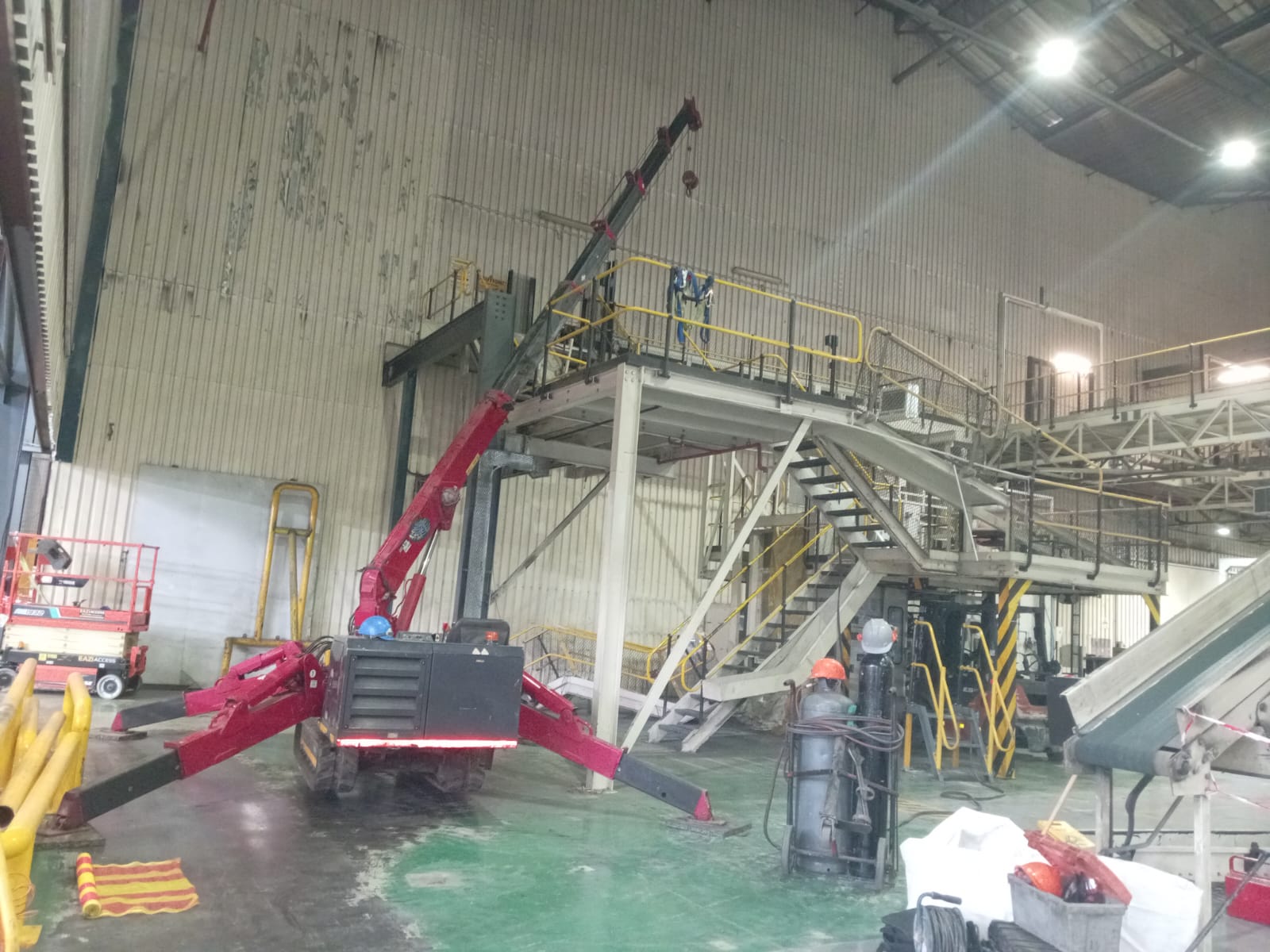 Spider crane installing mezzanine platform indoors