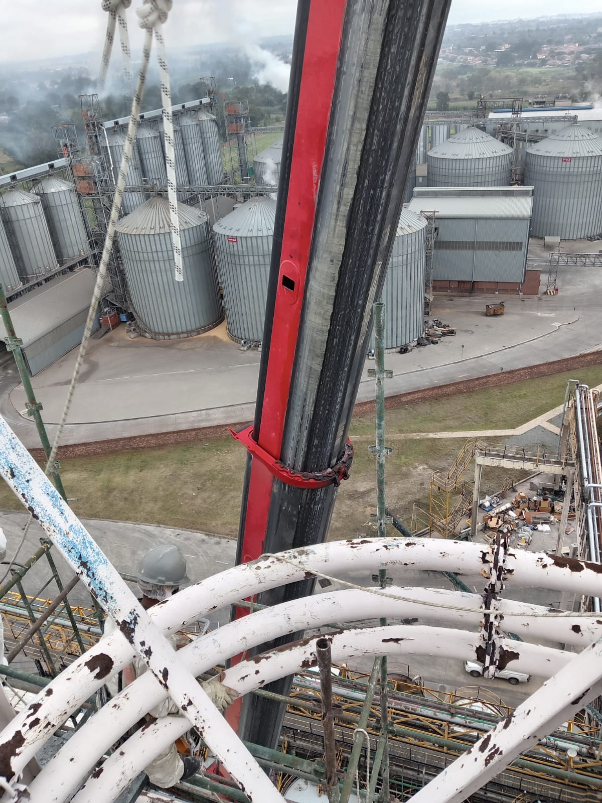 Aerial view of crane lift with grain silos