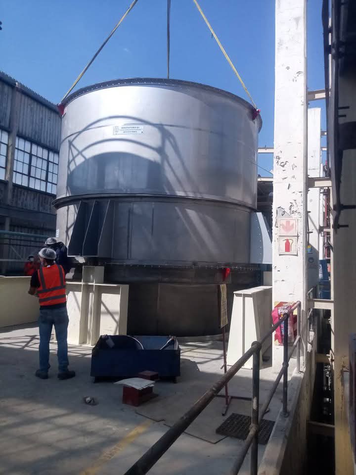 Large fabricated tank being lowered into position
