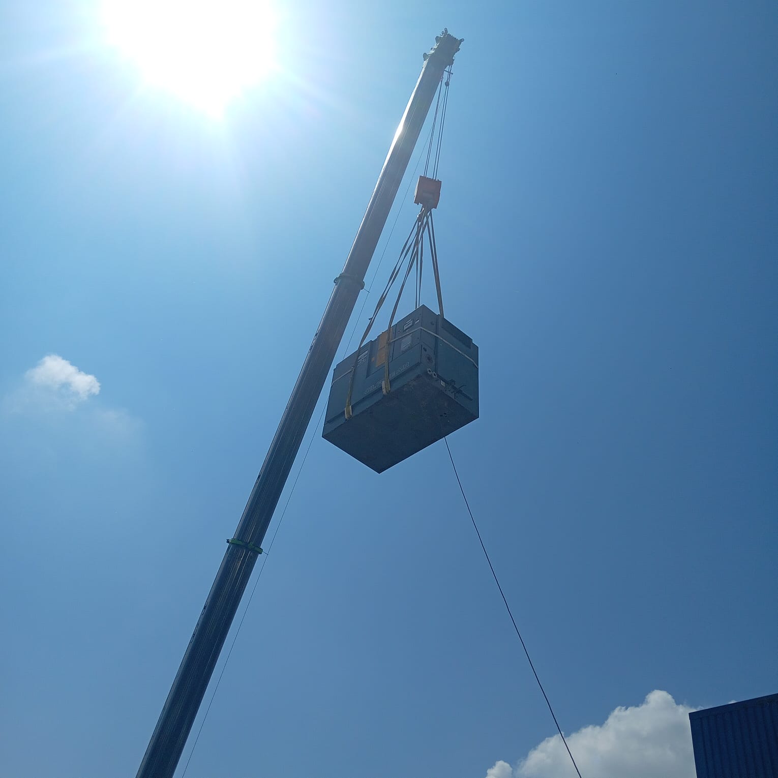 Crane lift in bright sunlight with lens flare