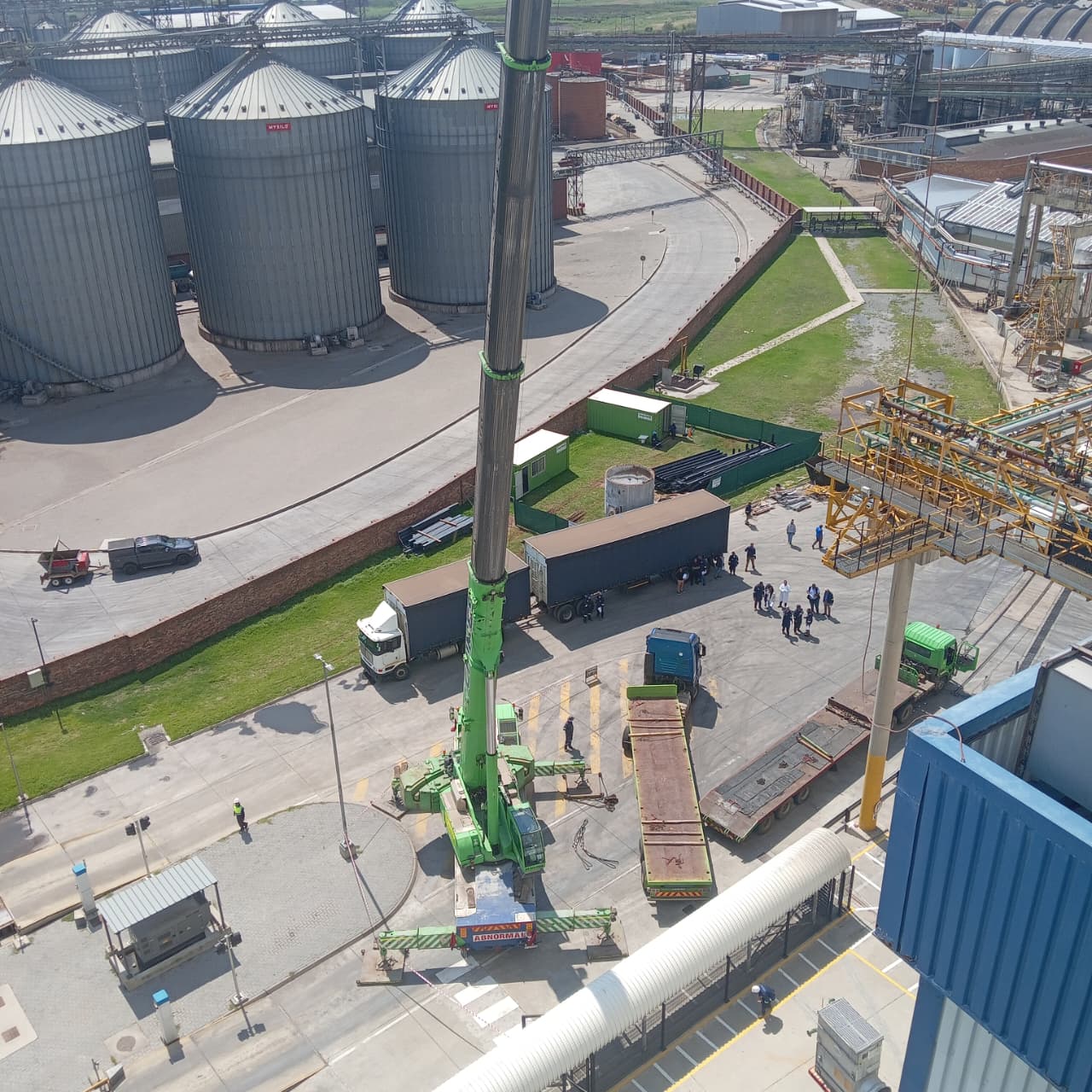 Aerial drone view of plant with crane and silos
